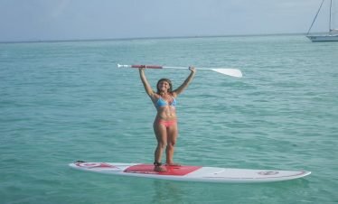 Paddleboarding activity during Akumal catamaran tour excursion